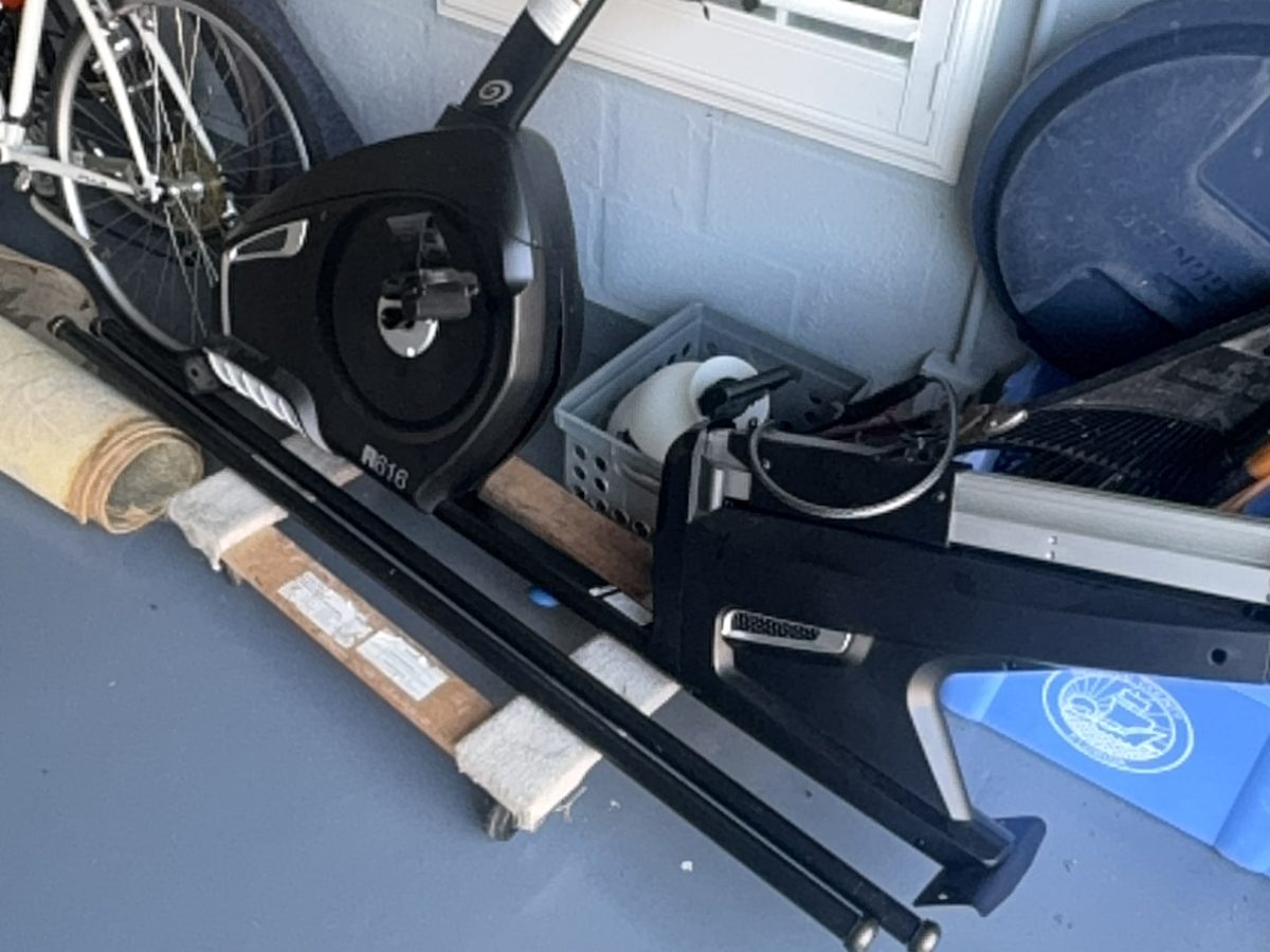 Exercise equipment, a bicycle and household items staged in a Manatee County garage for removal
